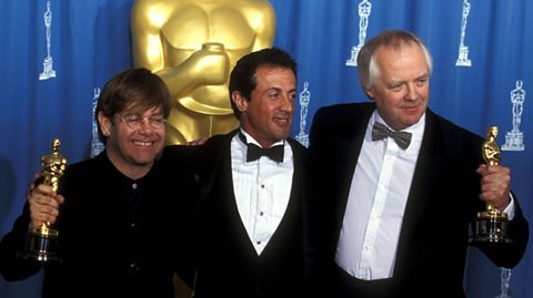 Elton John and Sir Tim Rice with their Oscars for Can You Feel the Love Tonight from Lion King, with Sylvester Stallone