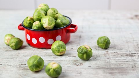 Brussels sprouts in a red saucepan