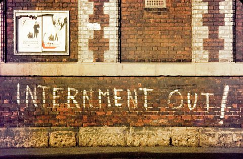 Graffiti reading 'INTERNMENT OUT!'