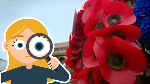 A close up of a poppy wreath in front of a building with a cartoon girl holding a magnifying glass to her eye in the foreground