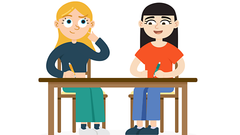 Two girls sitting at a desk smiling and thinking