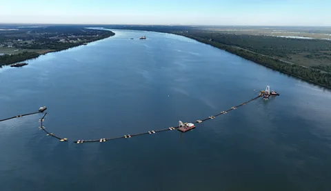 Getty Images US Army Corp of Engineers vessels in the Mississippi River use pipes to move dredged silt to hold back saltwater intrusion in 2023 (Credit: Getty Images)