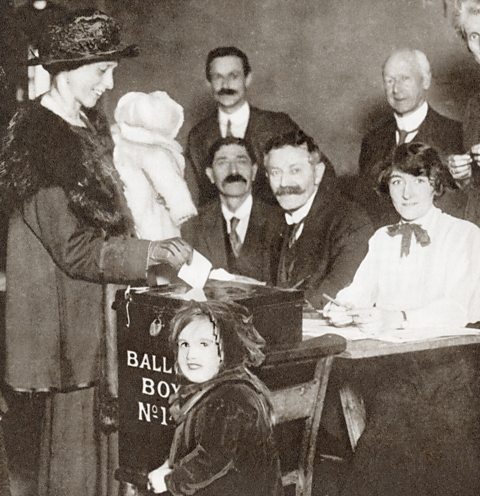 A woman votes at the 1918 General Election.