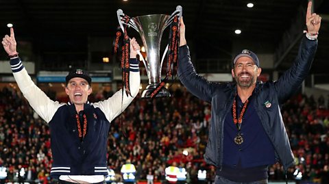 Rob McElhenney and Ryan Reynolds celebrate as Wrexham AFC are promoted to the English Football League after victory in the Vanarama National League 2022/23