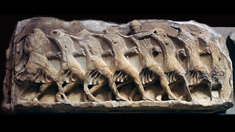 A marble frieze (wall decoration) showing soldiers in a phalanx formation, from the 5th century BC.