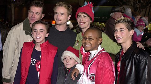 The cast of Malcolm in the Middle pose for a photo. From left to right, the cast members are Bryan Cranston (Hal), Frankie Muniz (Malcolm), Christopher Masterson (Francis), Erik Per Sullivan (Dewey), Jane Kaczmarek (Lois), Craig Lamar Traylor (Stevie), and Justin Berfield (Reece).