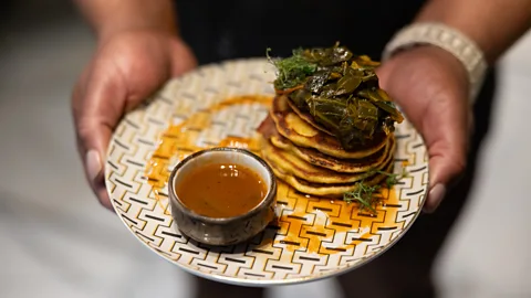 Lynsey Weatherspoon A chef presents a modern soul food dish, hoecakes and potlikker, at Auburn Angel restaurant in Atlanta, Georgia (Credit: Lynsey Weatherspoon)