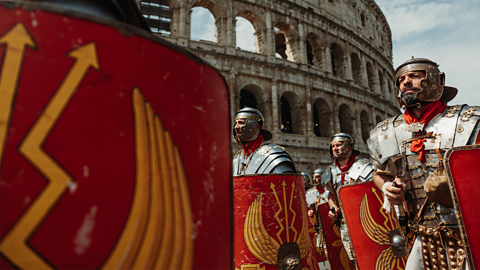 Roman re-enactors march past the Coliseum in Rome.