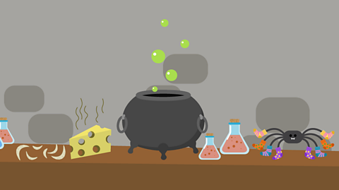 A desk with a cauldron on, some toenail clippings, smell cheese, two potions and a spider wearing socks.