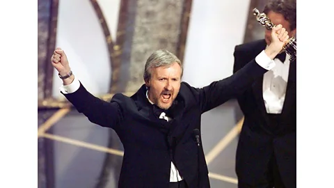 Getty Images James Cameron celebrating his best director win for Titanic – the film won 11 Oscars from 14 nominations (Credit: Getty Images)