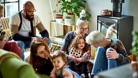 A multi-generational, multi-ethnicity family talking together