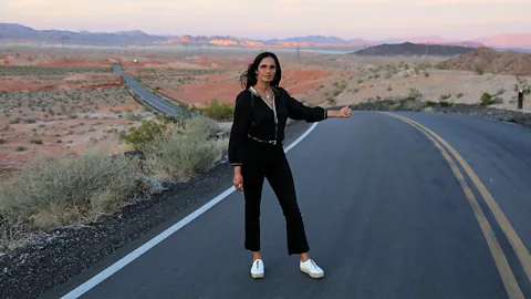 Courtesy of Padma Lakshmi Padma Lakshmi stands on an open road with the sunset behind her (Credit: Courtesy of Padma Lakshmi)