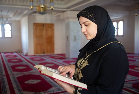 Muslim woman praying in mosque, reading Quran