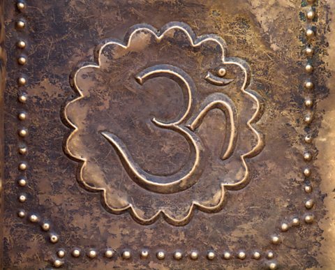 Brass Om symbol on a temple door