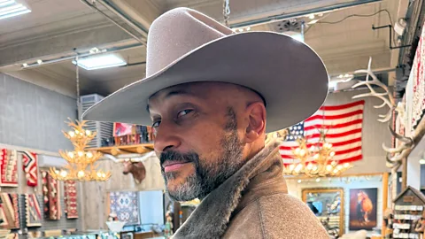 Courtesy of Keegan-Michael Key Comedian Keegan-Michael Key poses in a cowboy hat with a US flag in the background (Credit: Courtesy of Keegan-Michael Key)