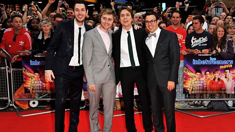 The stars of the Inbetweeners at their movie premiere on a red carpet with fans behind them