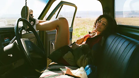HBO Max Zendaya as Rue in Euphoria season 3, sitting in the front seat of a truck with her feet up on the dashboard with her head turned to face the camera (Credit: HBO Max)