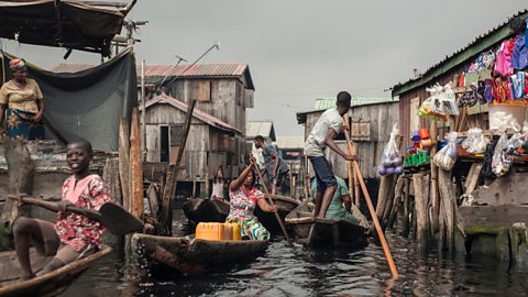 People navigate the waterways of Makoko waterfront community in Lagos.