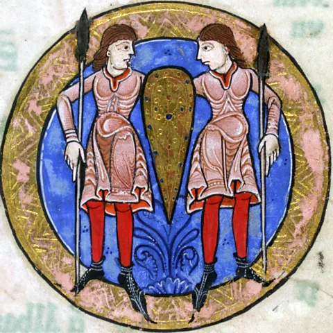 Getty Images Medieval illustration of two people holding spears but sharing a shield (Credit: Getty Images)