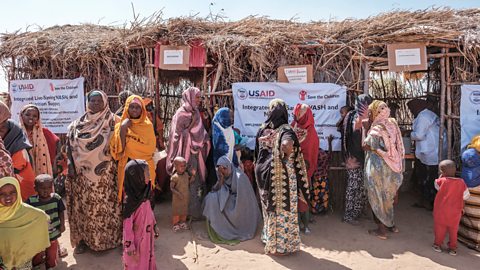  A crowd of women and children outside a mobile clinic in Ethiopia set up by NGO Save the Children