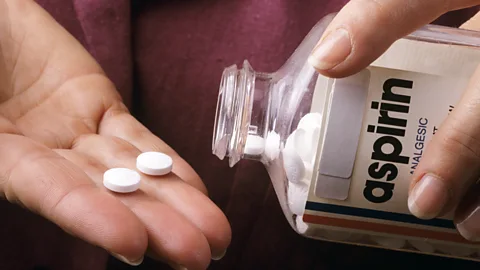 Getty Images A close up of someone pouring two tablets from a bottle of aspirin (Credit: Getty Images)