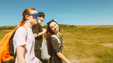 An image of three young people enjoying a stroll on a sunny day