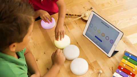 Children pressing colourful 'Cosmo dots' to produce musical sounds