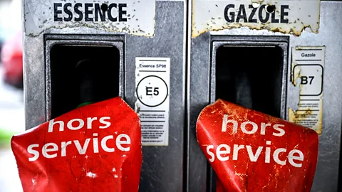 Getty Images Two gas pumps with red signs covering them which read hors service (out of service) (Credit: Getty Images)