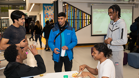 Image of a group of five young people at a youth centre having fun.