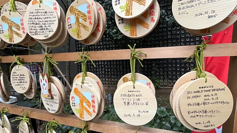 Erika Ebsworth-Goold From BTS to ZeroBaseOne, worshippers jot their specific concert requests onto wooden ema cards (Credit: Erika Ebsworth-Goold)