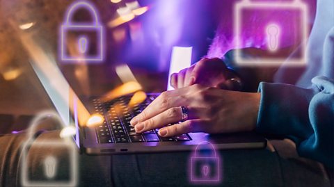 Female hands typing on a laptop in neon light. A lock as a symbol of cybersecurity on a foreground.