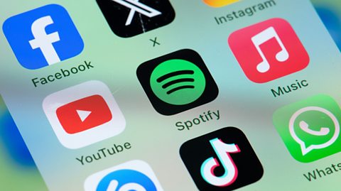 Image showing a cluster of icons on a smartphone screen with Spotify in the centre, surrounded by Facebook, YouTube, TikTok, X, Instagram and others