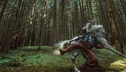 Neon A still of two men riding a horse through the woods, with one of the men mid-falling off, in Hope (Credit: Neon)