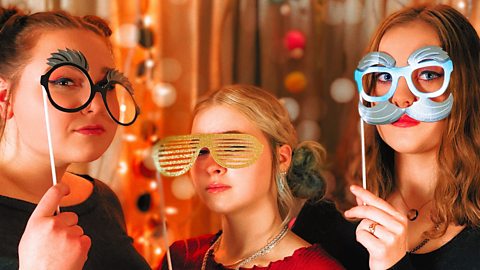 Teenagers with props doing a photoshoot.