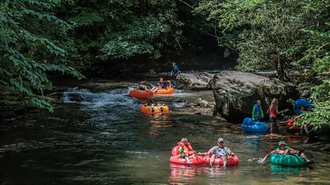 Getty Images The Smoky Mountains offers lower-cost outdoor activities, from hiking and cabin stays to river tubing (Credit: Getty Images)