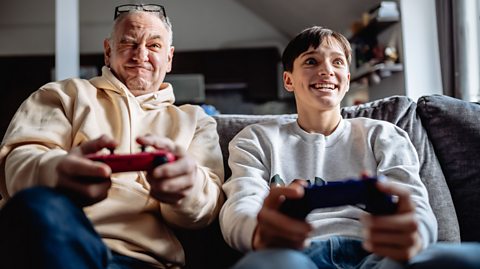 A foster parent playing games with his foster son.