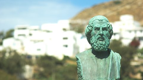 A landscape image of a bust statue of the poet Homer, who looks like an older man with a beard.