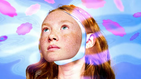 Serenity Strull/ BBC/ Getty Images Artwork which shows a young girl whose face is separated from the rest of her head looking towards the sky and surrounded by hazy pink flowers (Credit: Serenity Strull/ BBC/ Getty Images)
