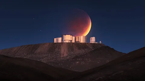 Yuri Beletsky (LCO A partially eclipsed Moon behind buildings of the Very Large Telescope on top of a ridge in the Atacama Desert (Credit: Yuri Beletsky (LCO)/ ESO)