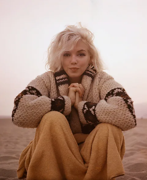 Photo: George Barris © INHOLLYWOODLAND.The George Barris Estate In the final photo of the shoot, Marilyn, hands clasped, seems to blow an affectionate kiss to the camera (Credit: Photo: George Barris © INHOLLYWOODLAND.The George Barris Estate)