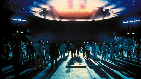 Alamy A crowd of people approach and glowing spaceship in Close Encounters of the Third Kind (Credit: Alamy)