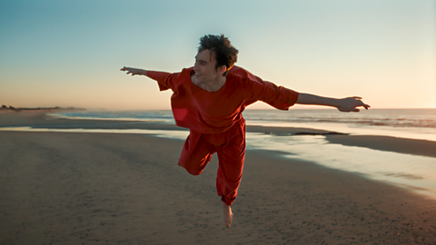 Jacob Collier floating in the air, an image still from Something Heavy music video