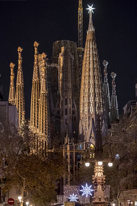Fundació Junta Constructora del Temple Expiatori de la Sagrada Família The Tower of the Virgin Mary, illuminated in the foreground and topped with a star (Credit: Fundació Junta Constructora del Temple Expiatori de la Sagrada Família/ Pep Daudé)