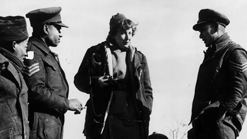 Getty Images A black-and-white photo of American war correspondent Martha Gellhorn talking with soldiers of the British Army on the Italian front in 1944 (Credit: Getty Images)