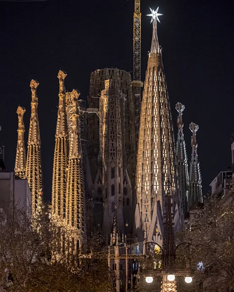 Sagrada Família / Pep Daudé The Tower of the Virgin Mary, illuminated in the foreground and topped with a star (Credit: Fundació Junta Constructora del Temple Expiatori de la Sagrada Família / Pep Daudé)