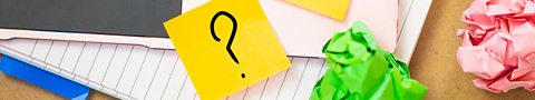 A question mark drawn on a sticky note. 