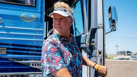 Netflix Will Ferrell stood at the front of a bus wearing a golfing gap in Hawk (Credit: Netflix)