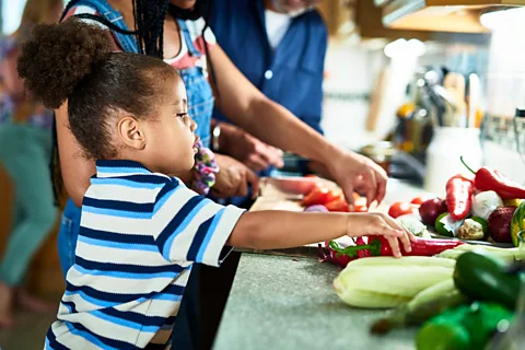 Getty Images Encouraging children to join in when cooking can also increase their desire to eat foods they are not familiar with (Credit: Getty Images)