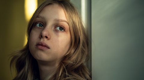 Anxious girl stares into space as she thinks