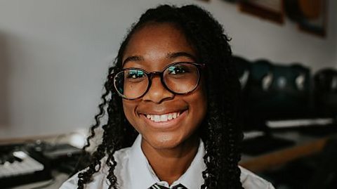 Happy teenager in school uniform.
